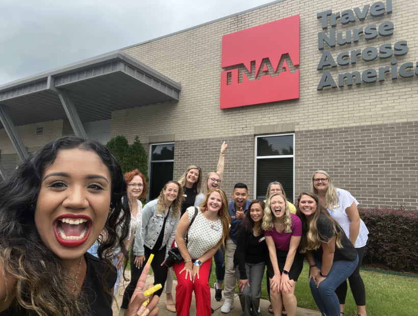 TNAA ambassadors and corporate employees posing in front of sign